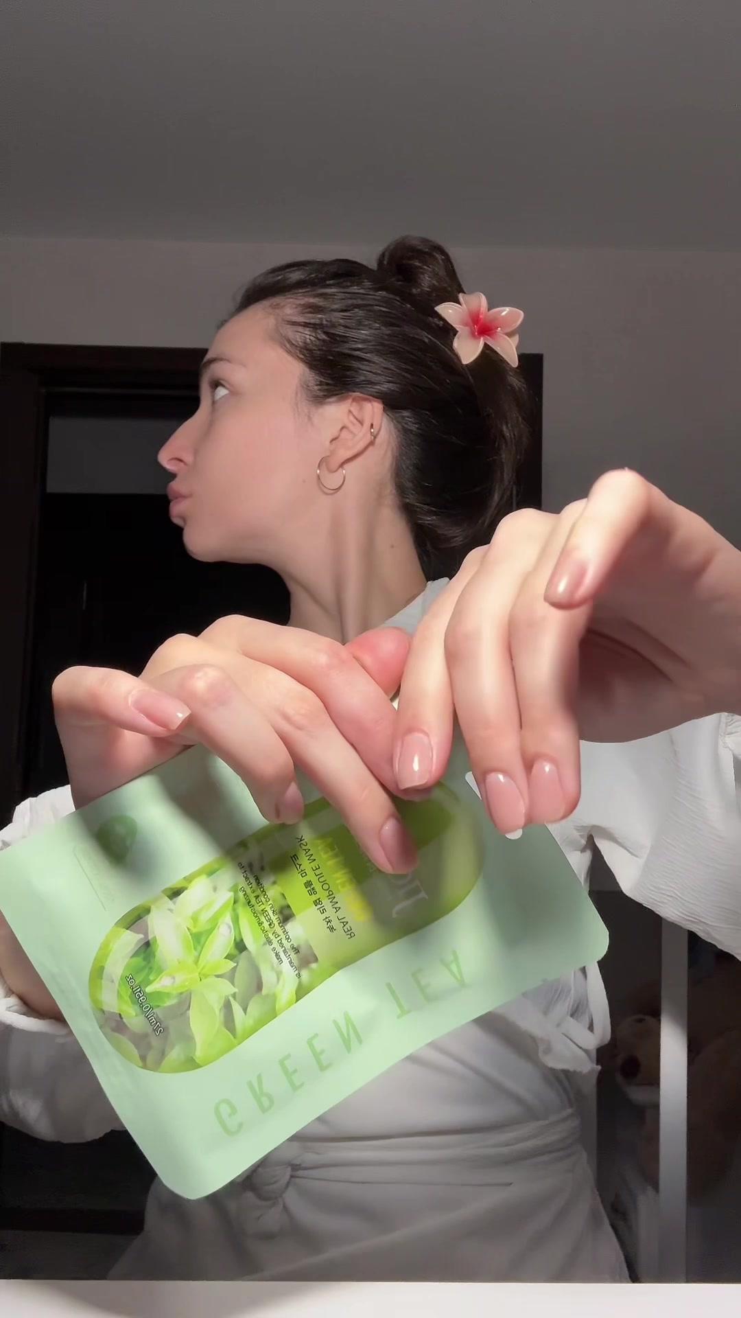 Woman Opening Green Tea Sheet Mask