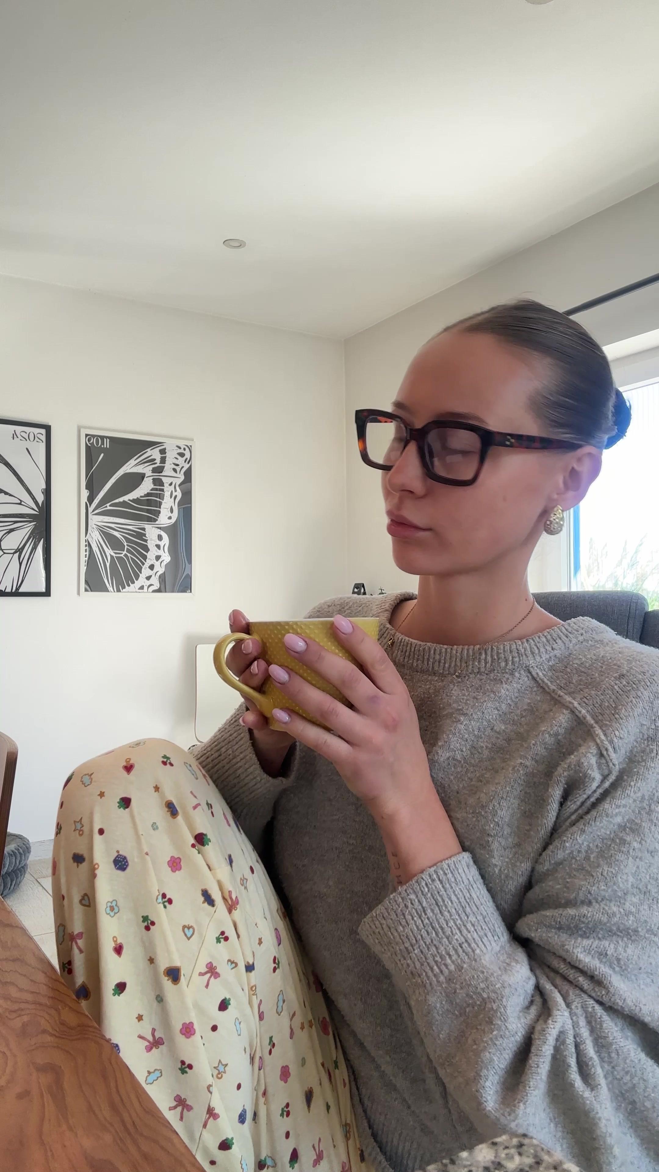 Woman Drinking Warm Beverage Indoors