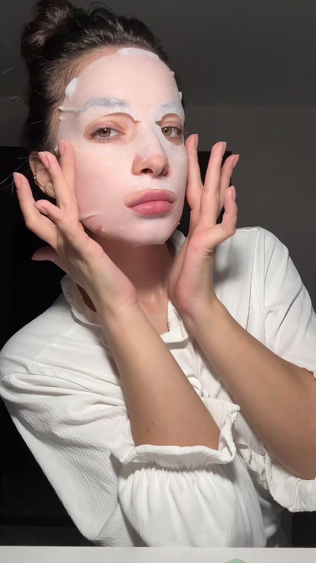 Woman Applying Sheet Face Mask