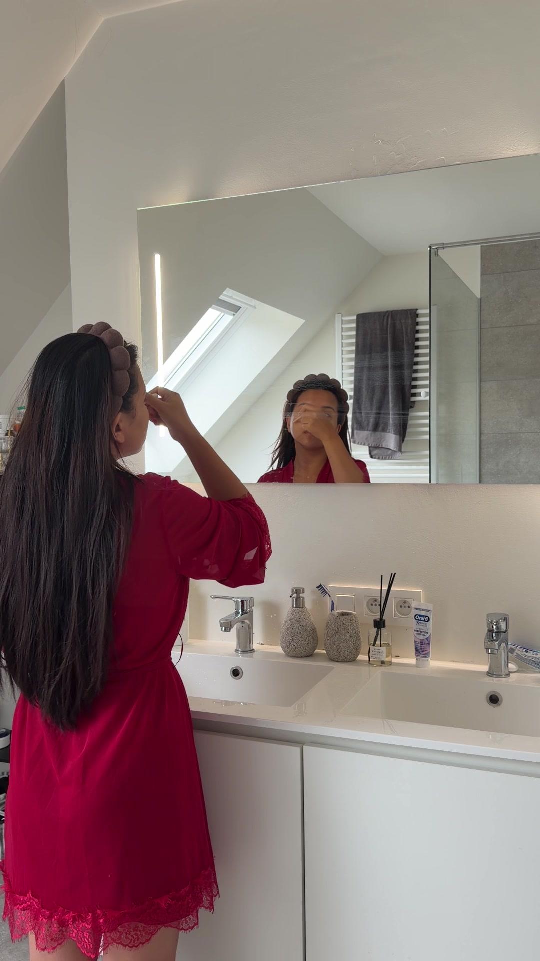 Woman Applying Face Makeup in Bathroom