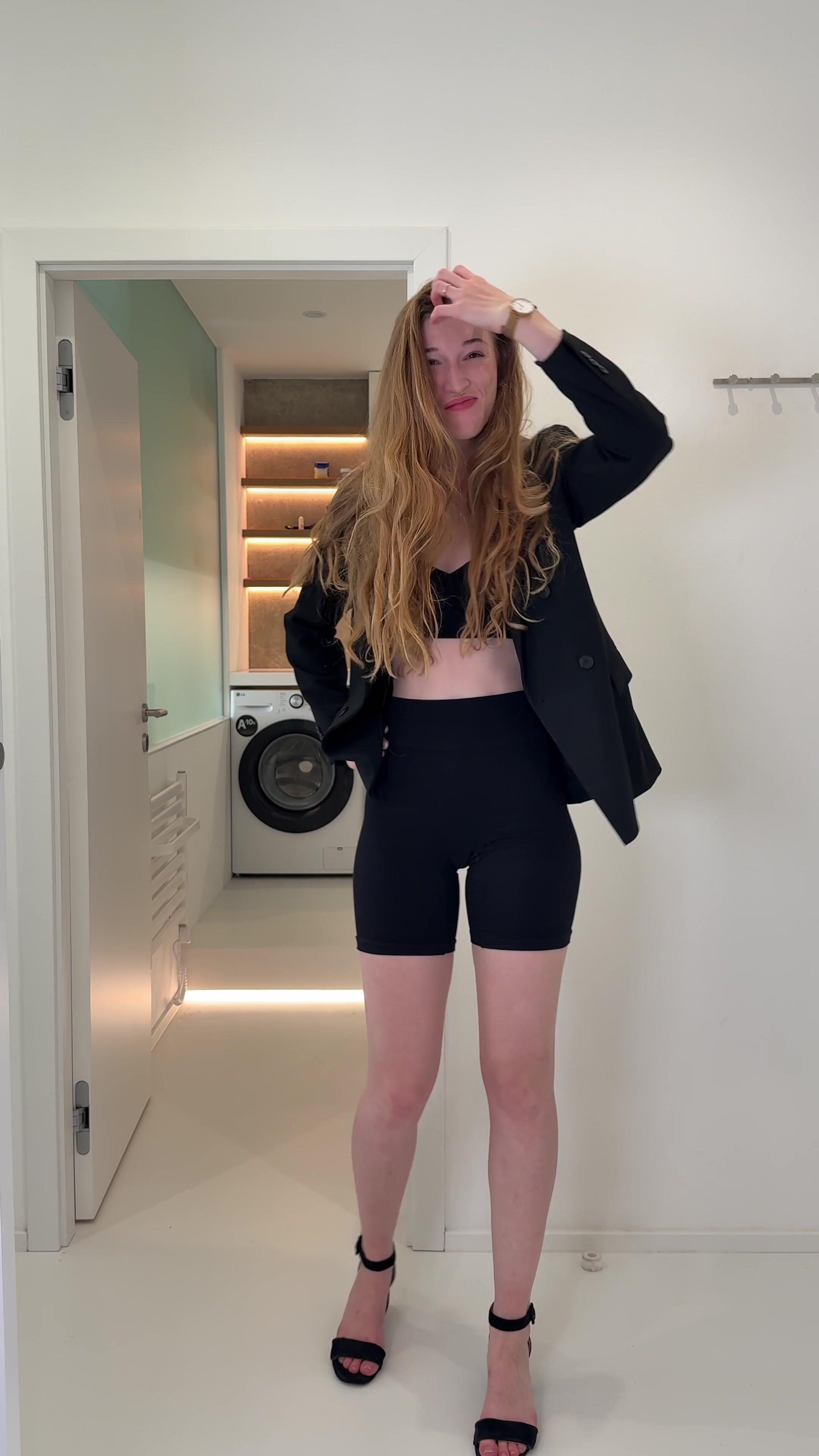 Confident Woman Posing and Styling Hair