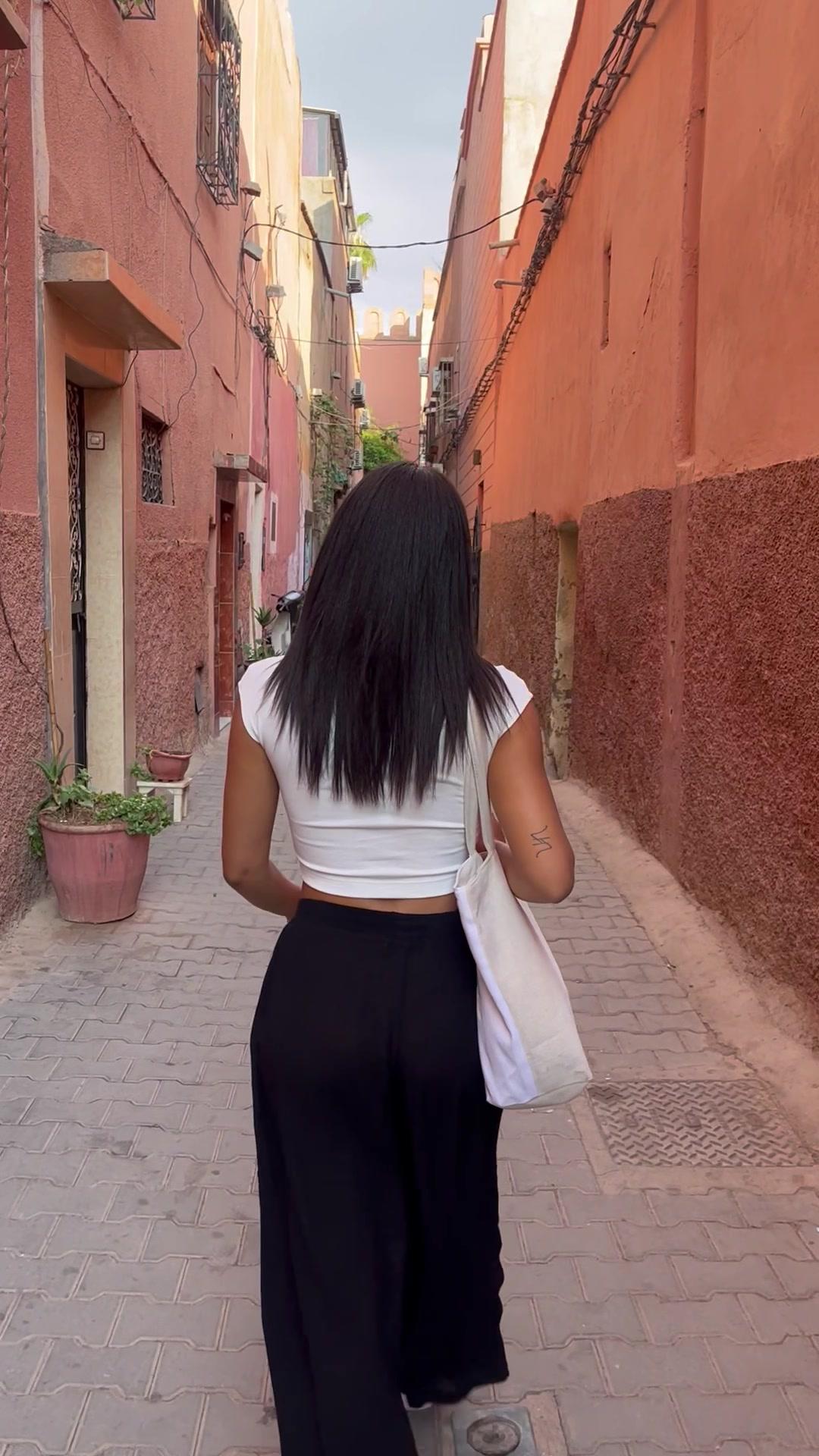 Woman Walking Down Moroccan Alley Turns Around