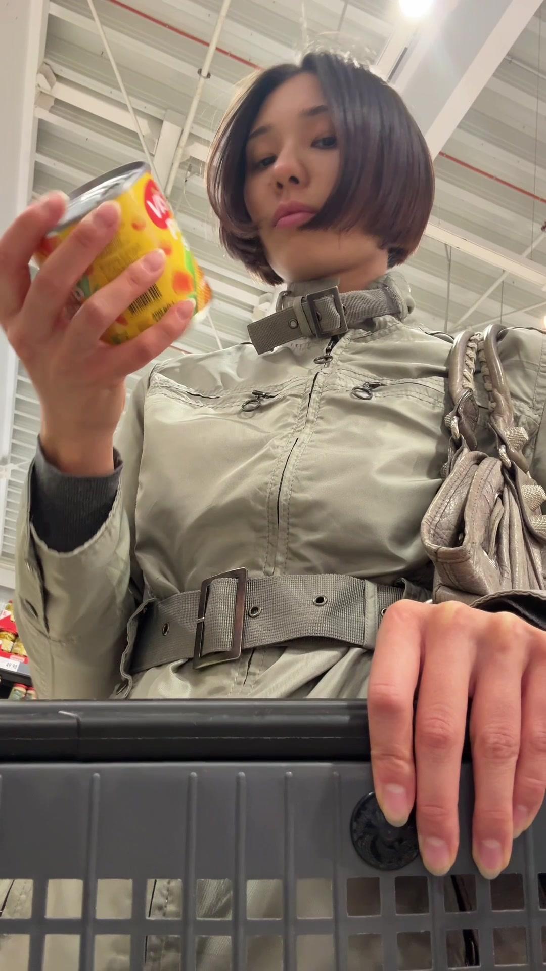 Woman Putting Groceries into Shopping Cart